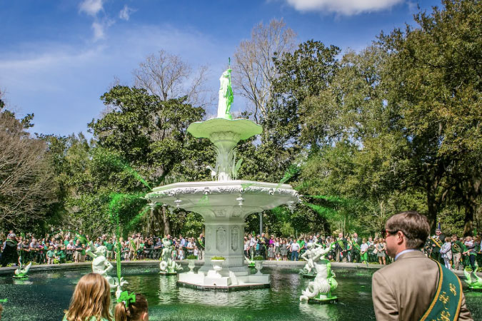 Tourists crowd around Savannah’s Forsyth Park Fountain, which has had its water dyed green in celebration of St. Patrick’s Day. 