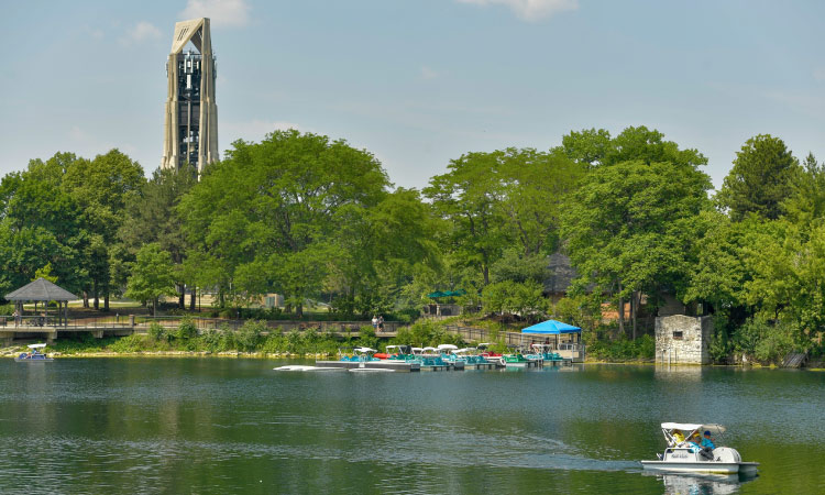 A tranquil scene at Quarry Lake in Naperville, Illinois, as a small boat glides peacefully on the water.