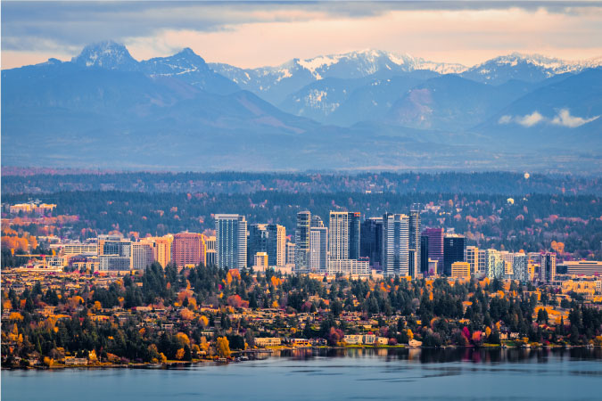 View from across the lake of Bellevue and distant snow-peaked mountains.