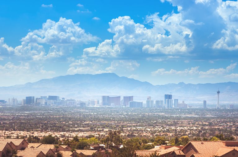 Distant view of the Las Vegas skyline from over the rooftops of suburban homes