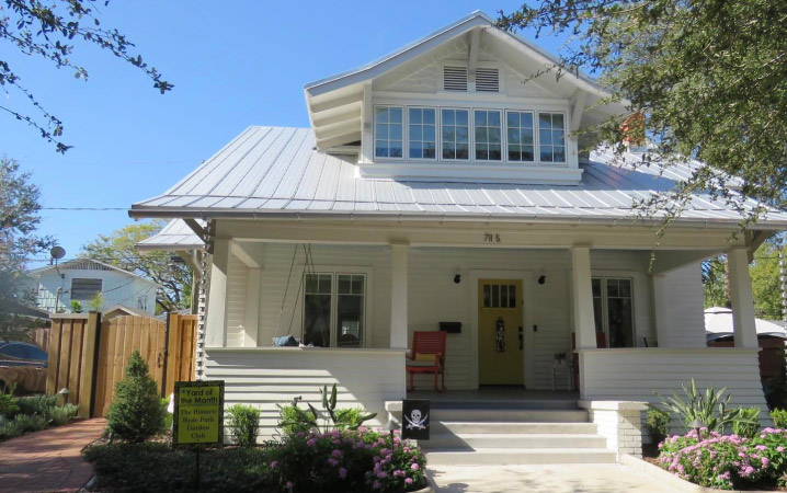 A gorgeous two-story residential home in Tampa’s Hyde Park neighborhood with a large covered porch and beautifully landscaped yard.