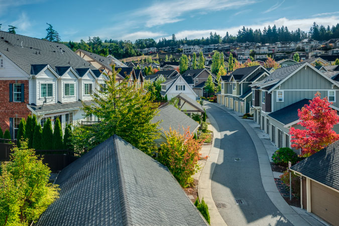 A residential street winds through a quiet neighborhood in Issaquah, Washington, in the summer. 