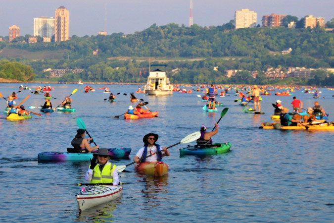 Locals take to the water for the Ohio River Paddlefest in Cincinnati, Ohio, on a beautiful summer day.