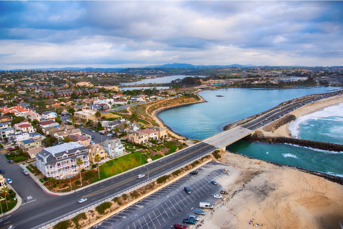 Aerial view of the Agua Hedionda Lagoon and Tamarack Beach in Carlsbad, California, on an overcast day