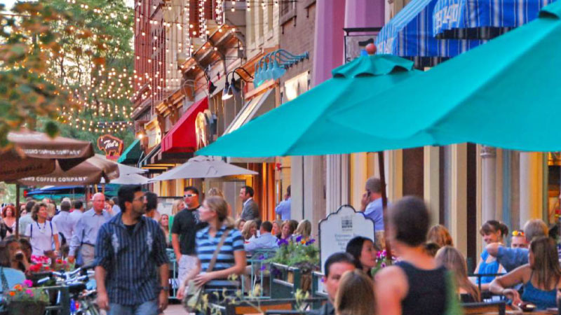 Lower Downtown (LoDo) in Denver, Colorado. Dozens of locals and visitors are dining al fresco at various restaurants.  