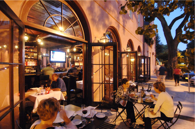 Diners enjoy the upscale ambiance of The Olde Pink House in Savannah, Georgia.