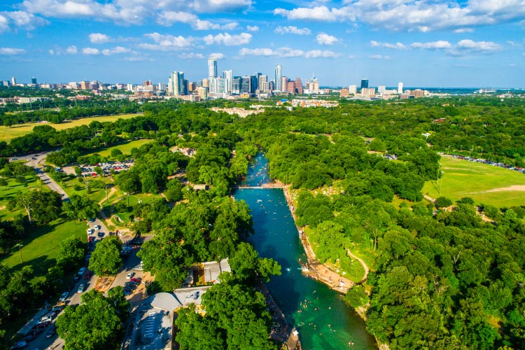 Aerial view of Barton Springs and the skyline of Austin, Texas. The Springs are just 8 miles from nearby Barton Creek, Texas. 