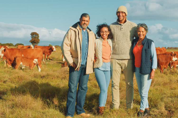 A recently retired couple poses for a photo with their adult son and granddaughter at their new Texas ranch. 