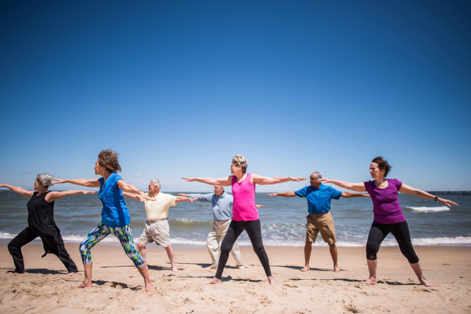 Seven seniors from Westminster-Canterbury on Chesapeake Bay are taking part in a beach yoga class