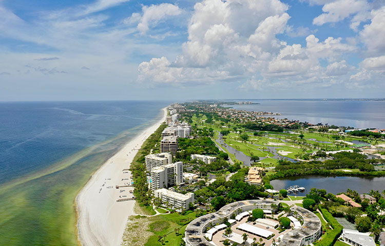 An aerial view of Longboat Key, Florida. Condos line the shore, and the beach seems to stretch on forever.