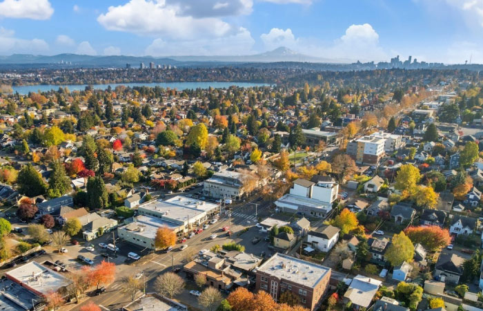 Aerial view of Seattle’s Phinney Ridge neighborhood with downtown Seattle and Mt. Rainier visible in the distance.