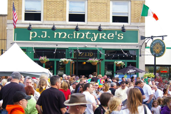 Locals gather in front of P.J. McIntyre’s during The Hooley on Kamm’s Corners, a street festival held in the Kamm’s Corners neighborhood of Cleveland, Ohio.