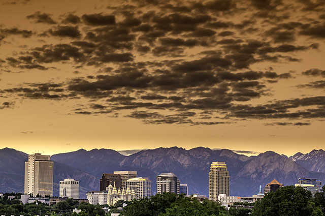 Distant view of the Downtown Salt Lake City Skyline at dusk with the mountains in the background.