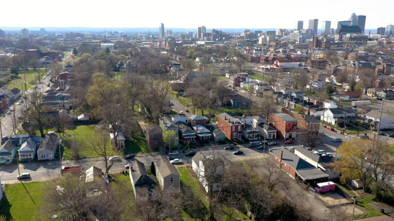 Aerial view of the Shelby Park neighborhood in Louisville, Kentucky, with the city skyline in the distance.