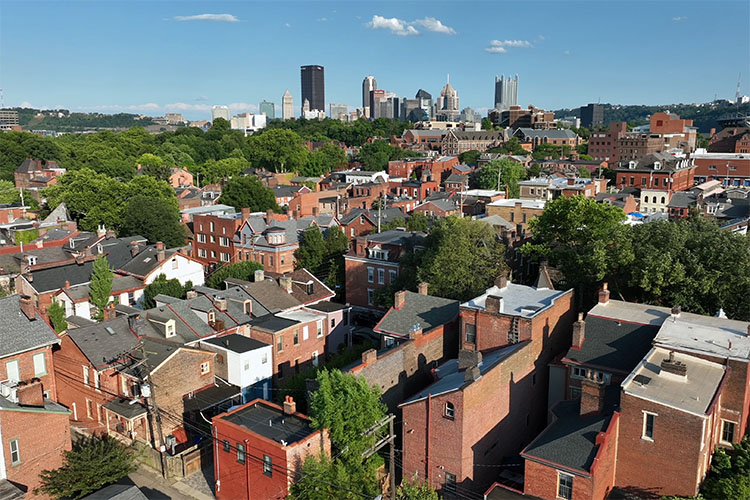 A rooftop view of the Squirrel Hill neighborhood, with Pittsburgh’s downtown skyline in the distance