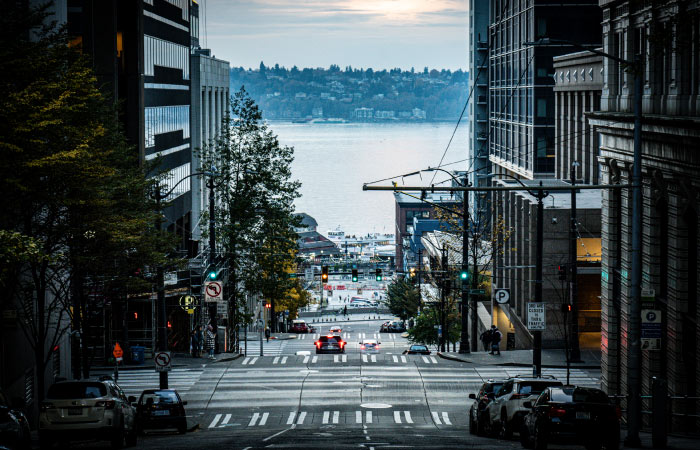 A street-level view of Downtown Seattle looking toward the water.