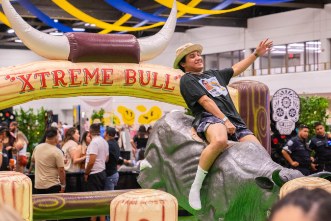 An El Paso local rides a mechanical bull at the Sun City Craft Beer Fest in El Paso, Texas.