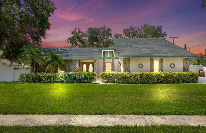 Sunset view of a charming one-story home in Lake Magdalene — one of the best Tampa suburbs.