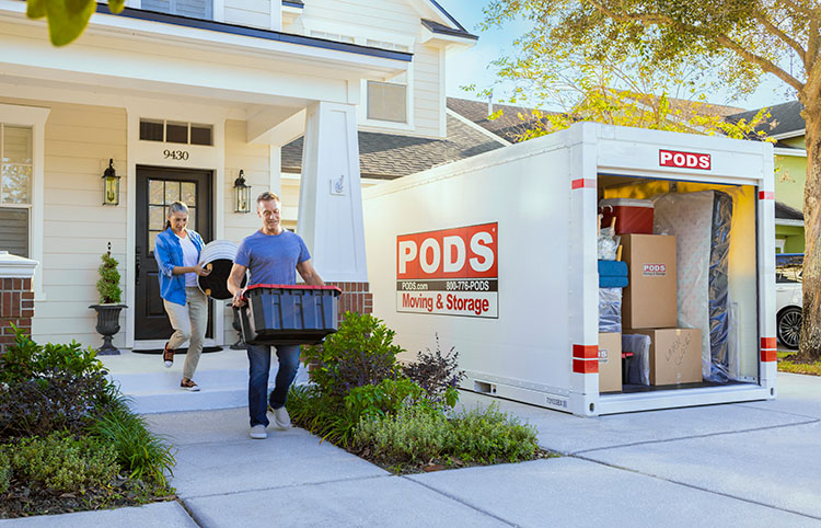 A husband and wife load up their PODS container. 