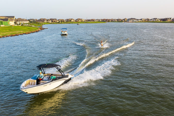 Boaters enjoying a sunny day on the water in the Towne Lake community of Cypress, Texas.