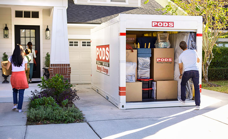 A family of four unloads their ӰPro container in their Tucson home after moving to town.