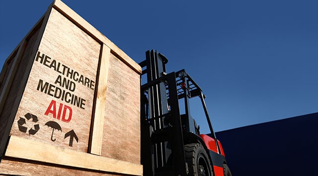 Crate filled with healthcare and medicine supplies being lifted on a forklift 