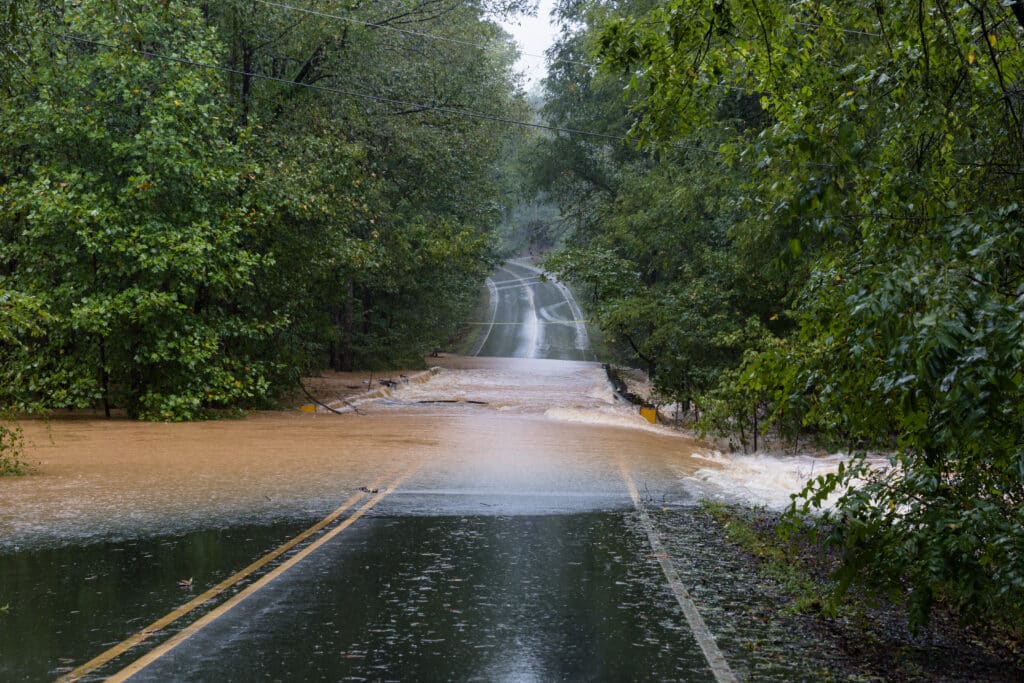 Low point of country road covered in water from a flash flood