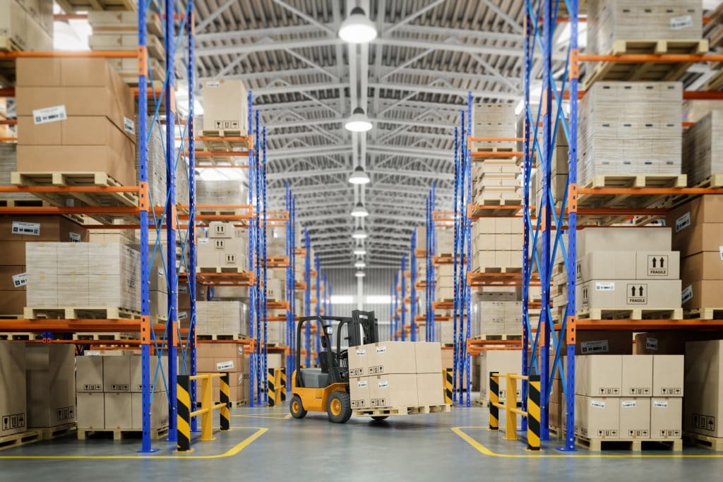 Forklift moving moving parcels and cargo inside a warehouse