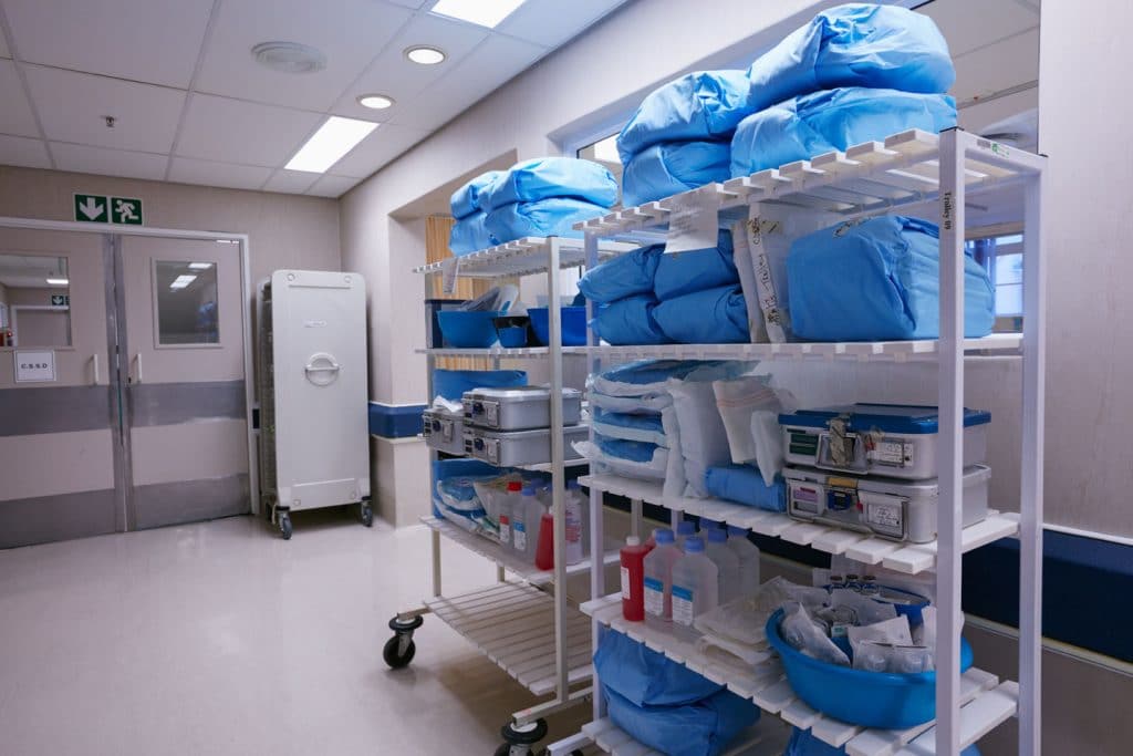 Large shelves of medical supplies inside a healthcare facility